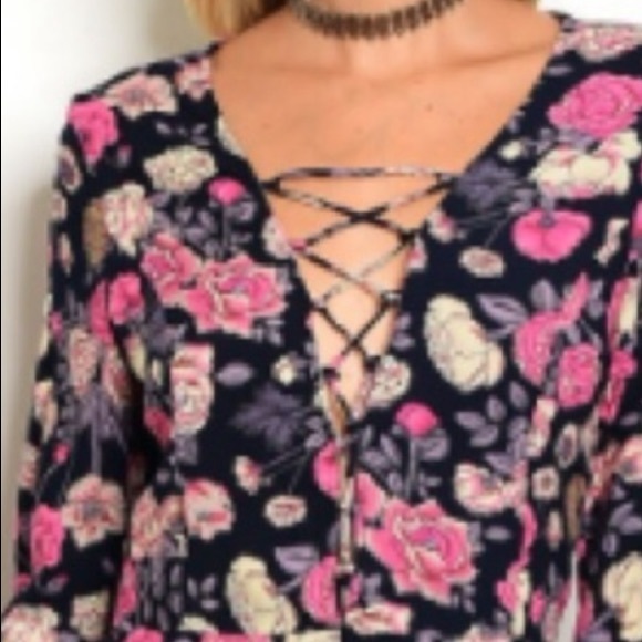 trendy boutique Pants - Navy floral romper with a plunge lace-up neckline.
